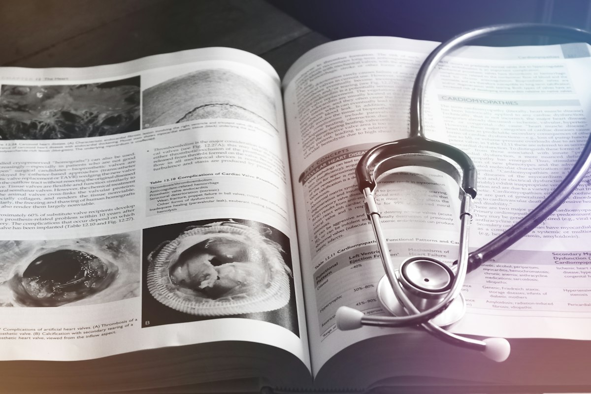 Stethoscope resting on an open medical book